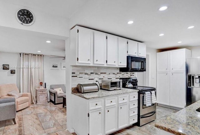 kitchen with decorative backsplash, light stone counters, white cabinetry, and appliances with stainless steel finishes