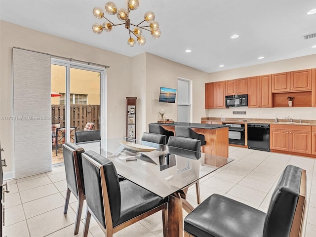 tiled dining space featuring sink and a notable chandelier