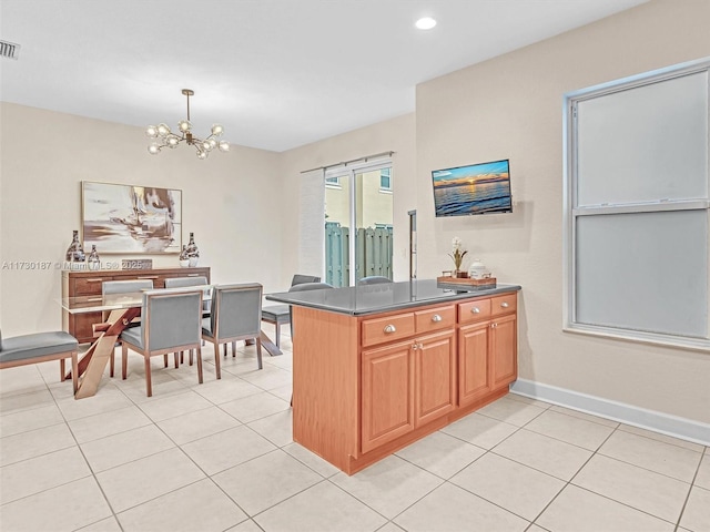 kitchen with hanging light fixtures, light tile patterned floors, a notable chandelier, and kitchen peninsula