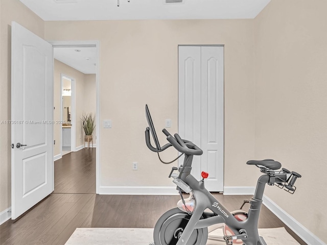 workout area with hardwood / wood-style flooring