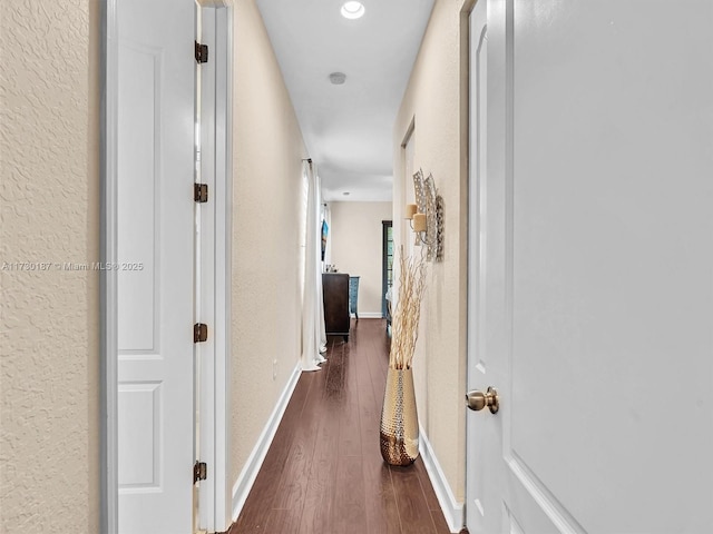 hallway with dark wood-type flooring