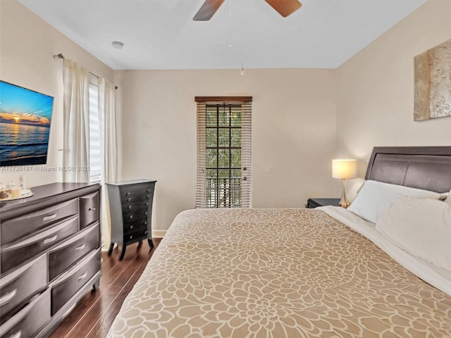 bedroom with dark wood-type flooring, ceiling fan, and multiple windows