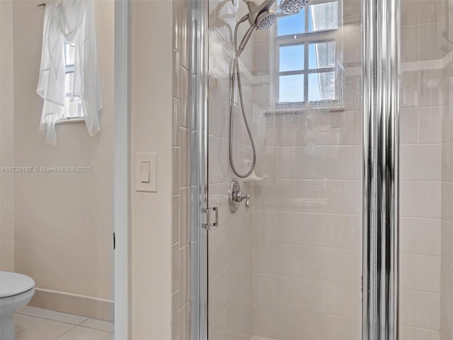 bathroom with an enclosed shower, tile patterned flooring, and toilet