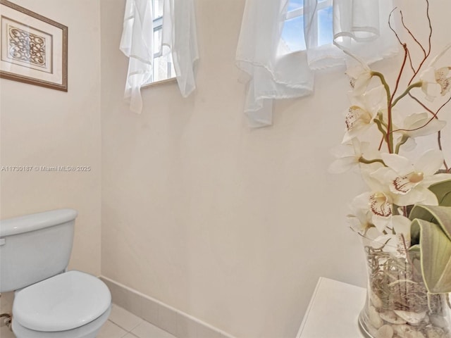 bathroom with plenty of natural light, tile patterned floors, and toilet