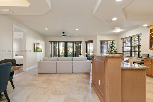 living room with ceiling fan and plenty of natural light