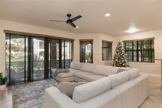 living room with light tile patterned floors and ceiling fan