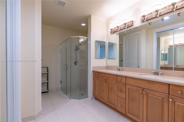 bathroom featuring tile patterned flooring, walk in shower, and vanity