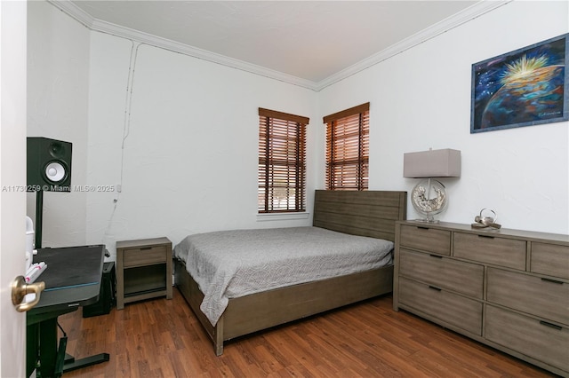 bedroom with ornamental molding and dark hardwood / wood-style floors