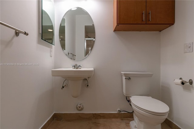 bathroom with toilet and tile patterned flooring