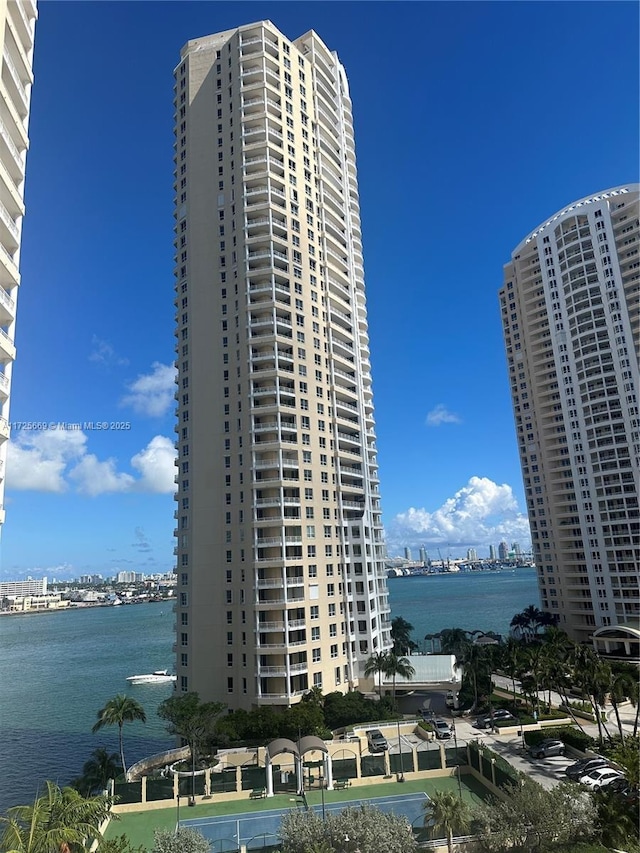 view of building exterior with a view of city and a water view