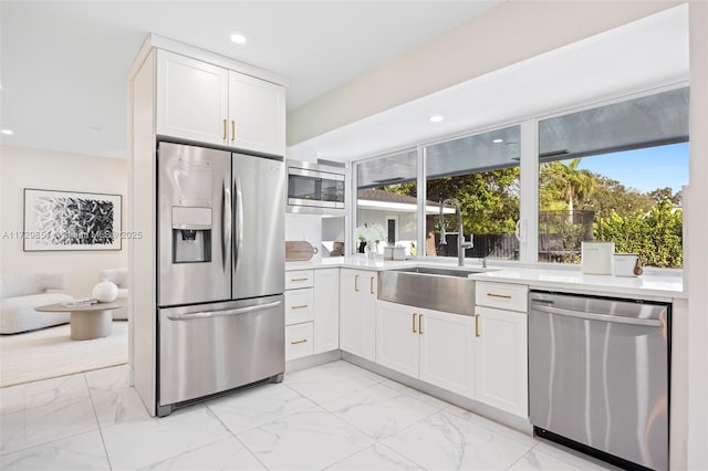 kitchen with sink, stainless steel appliances, and white cabinets