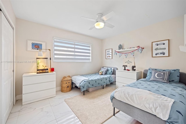 bedroom featuring ceiling fan and a closet