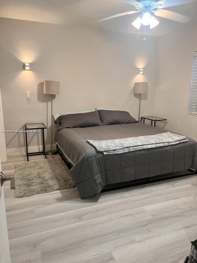 bedroom featuring ceiling fan and light hardwood / wood-style flooring