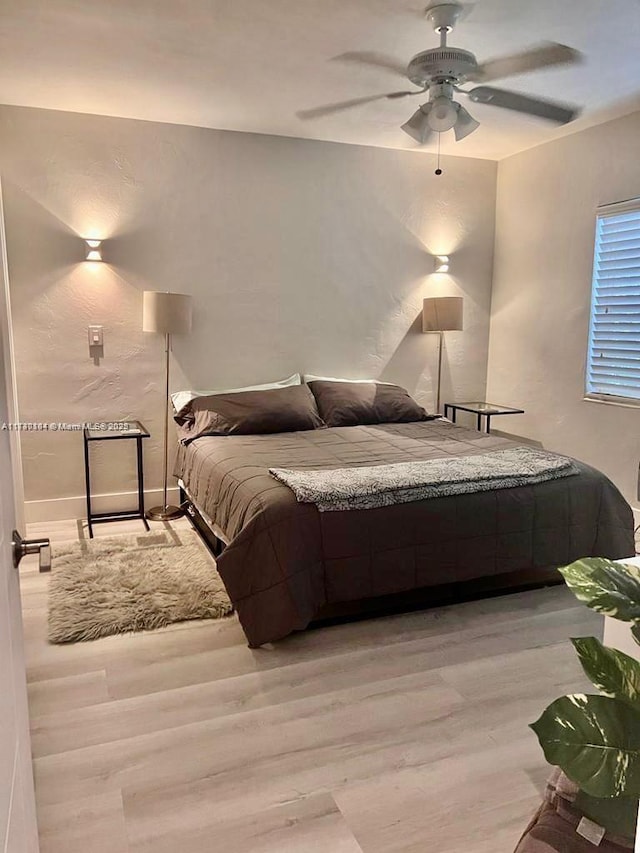 bedroom featuring ceiling fan and light hardwood / wood-style floors