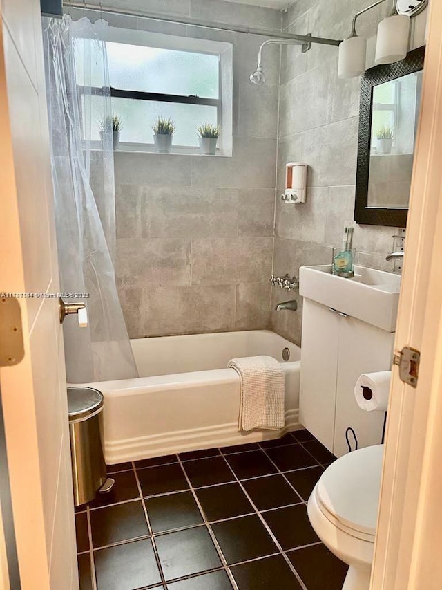 full bathroom featuring shower / tub combo, tile patterned flooring, tile walls, toilet, and vanity