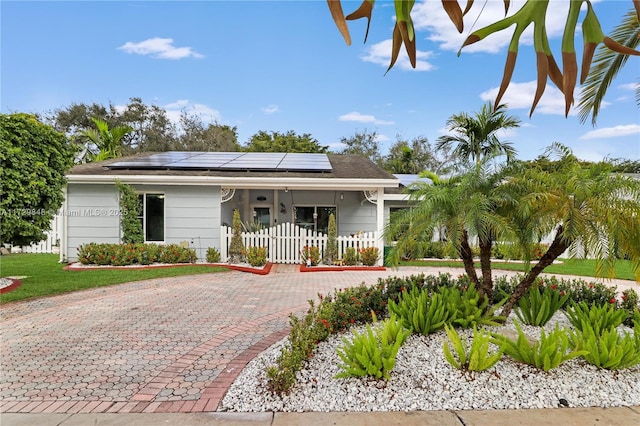 view of front of house featuring solar panels