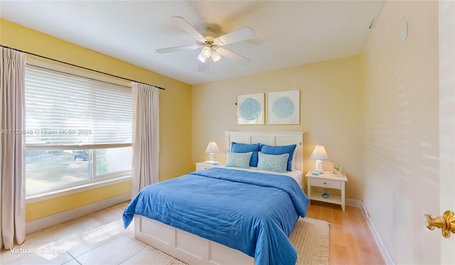 bedroom with ceiling fan and light wood-type flooring