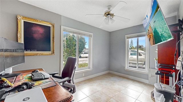 office featuring light tile patterned floors, a healthy amount of sunlight, and ceiling fan