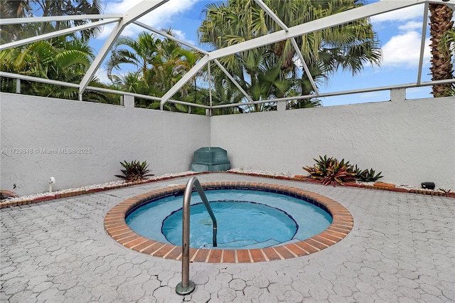 view of swimming pool with a hot tub