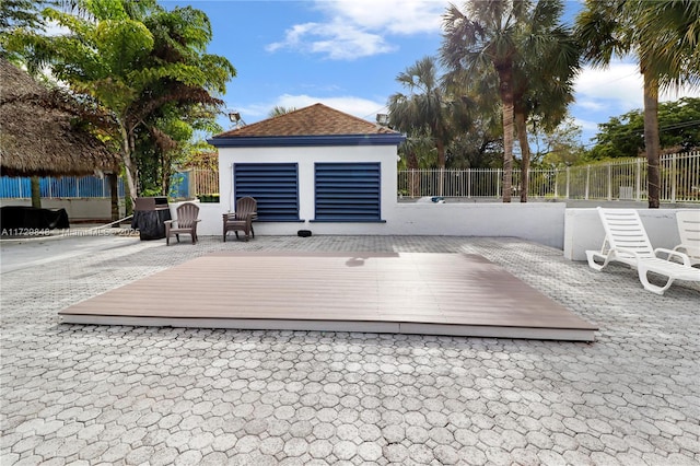 deck featuring an outbuilding and a patio