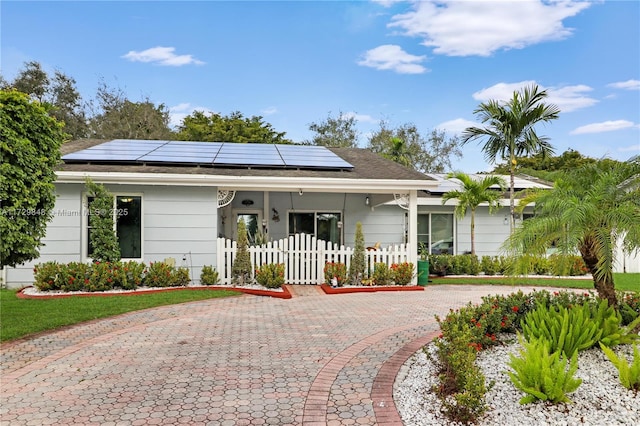 view of front of property featuring solar panels