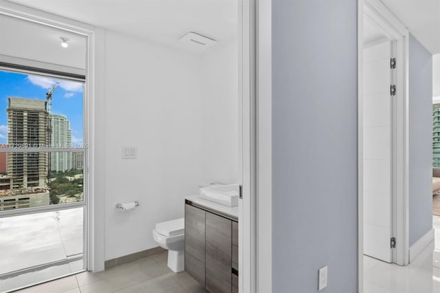 bathroom featuring toilet, tile patterned floors, and vanity