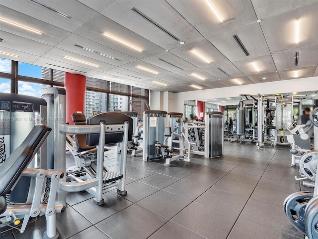 exercise room featuring a wall of windows and a healthy amount of sunlight