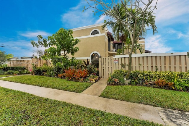 mediterranean / spanish-style house with a front lawn