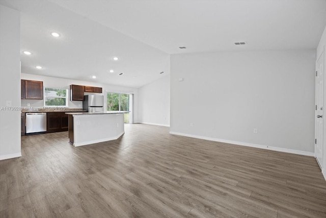 kitchen featuring dark wood-type flooring, appliances with stainless steel finishes, and a center island