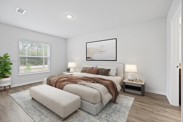 bedroom with light hardwood / wood-style floors