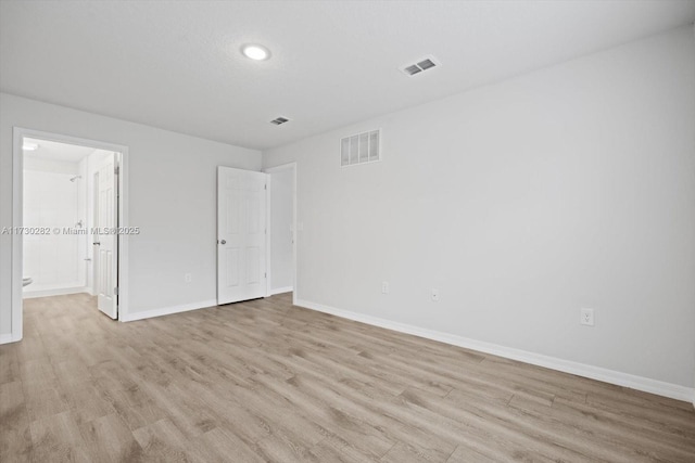 unfurnished room with light wood-type flooring