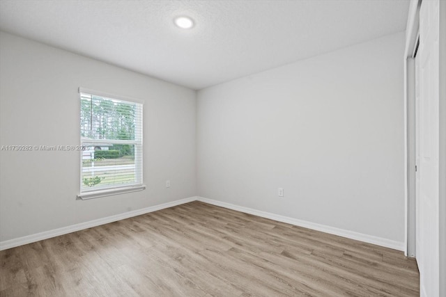 empty room with light hardwood / wood-style floors