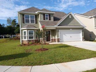 view of front of home featuring a garage and a front lawn