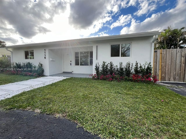 single story home featuring a front yard