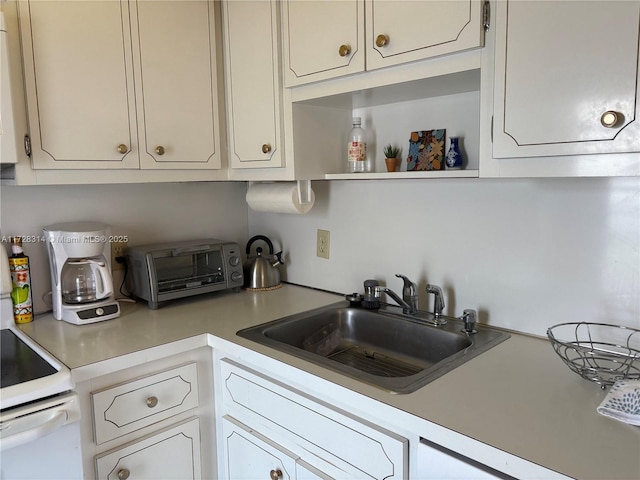 kitchen with white cabinetry and sink