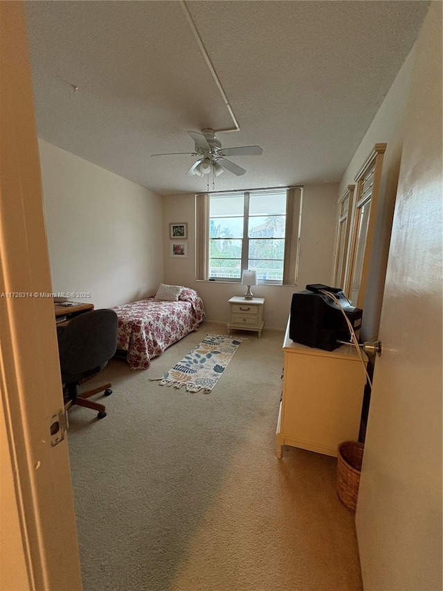 unfurnished bedroom with light carpet and ceiling fan