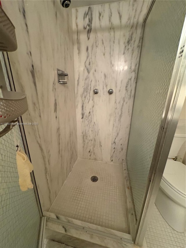 bathroom with walk in shower and toilet