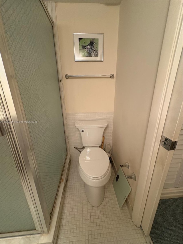 bathroom with walk in shower and toilet