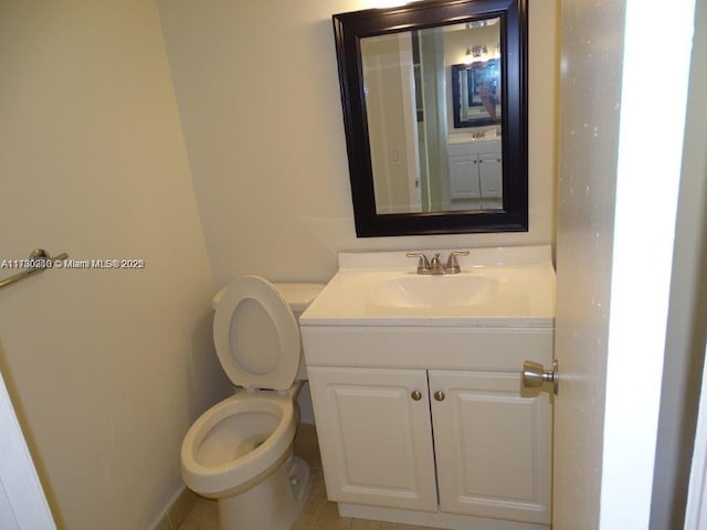 bathroom featuring toilet and vanity