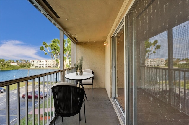 balcony featuring a water view