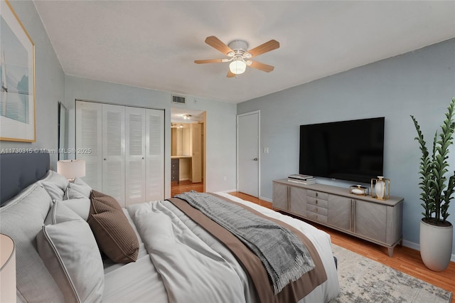 bedroom with a closet, ceiling fan, and light hardwood / wood-style flooring