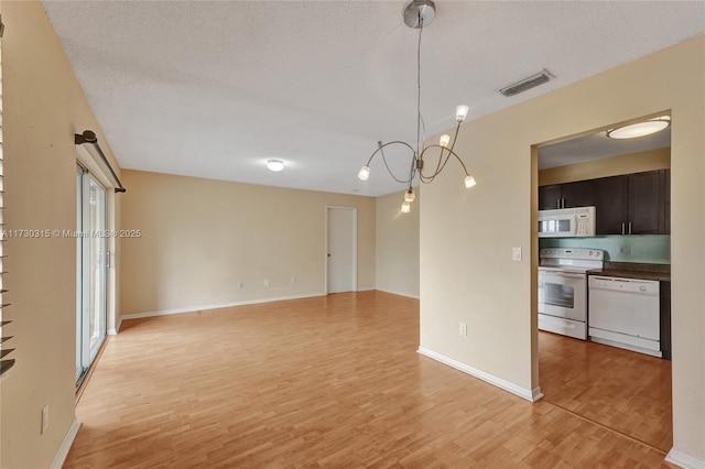 interior space with a textured ceiling and light hardwood / wood-style flooring