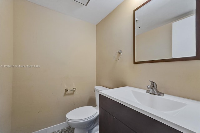 bathroom with toilet and vanity