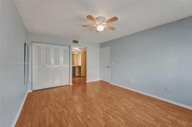 unfurnished bedroom featuring light hardwood / wood-style flooring, a closet, and ceiling fan