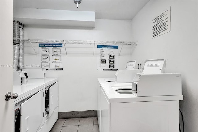 laundry room with light tile patterned flooring and separate washer and dryer