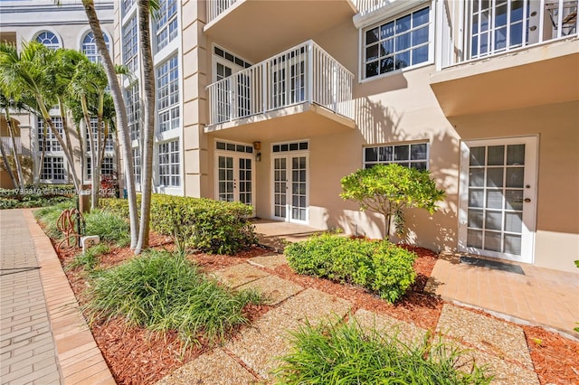 exterior space featuring stucco siding and french doors