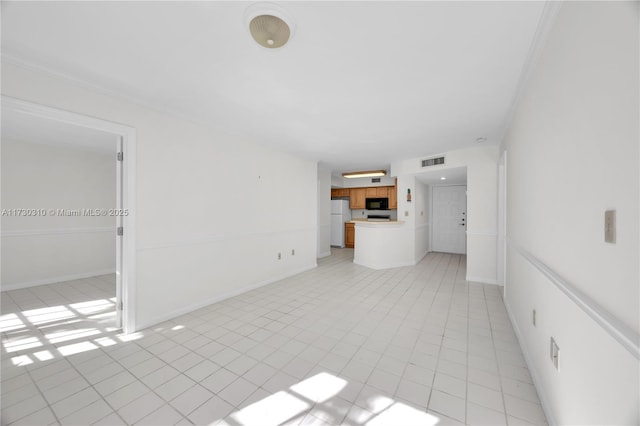 unfurnished living room featuring a tiled fireplace, visible vents, baseboards, and light tile patterned floors