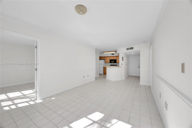 unfurnished living room with visible vents, baseboards, and light tile patterned floors