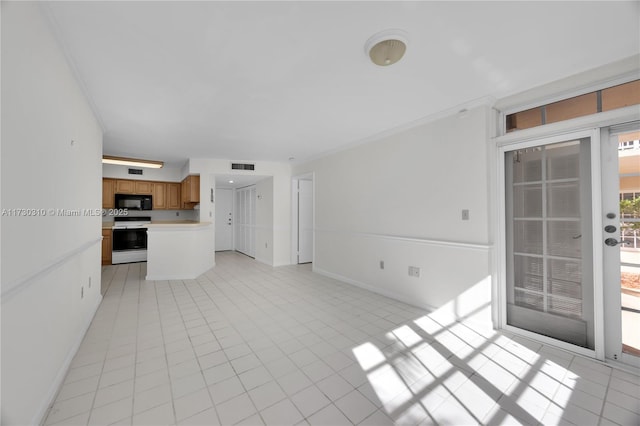 unfurnished living room with visible vents, baseboards, and light tile patterned floors