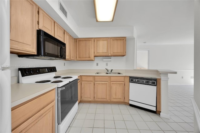 kitchen featuring white appliances, light brown cabinets, a sink, and visible vents